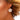 Close-up of a woman wearing a floral earring with a blurred background