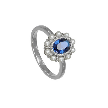 A silver ring featuring an oval-cut blue gemstone surrounded by a halo of small silver pearls