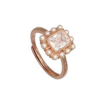 A rose gold adjustable ring featuring a central clear cushion-cut gemstone surrounded by a halo of small white pearls.