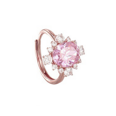 A rose gold ring featuring a large oval pink gemstone surrounded by a halo of small clear stones