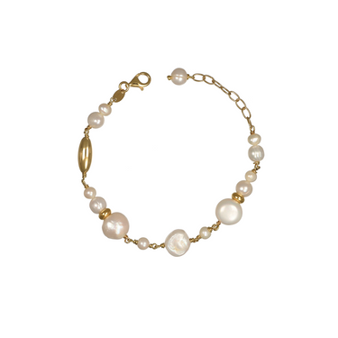 A gold chain bracelet featuring irregular white baroque pearls and small gold spacer beads.