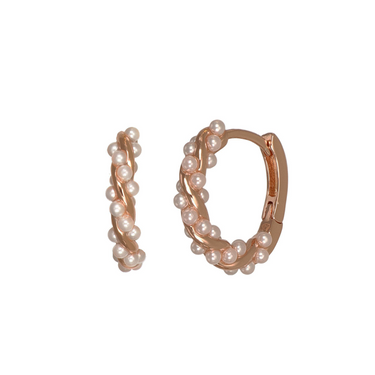Rose gold huggie hoop earrings adorned with small white pearls, shown on a plain white background.