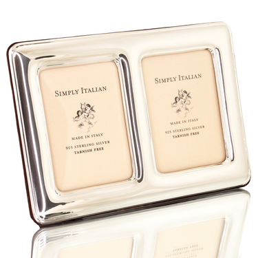 A sterling silver double picture frame with a polished wood back,