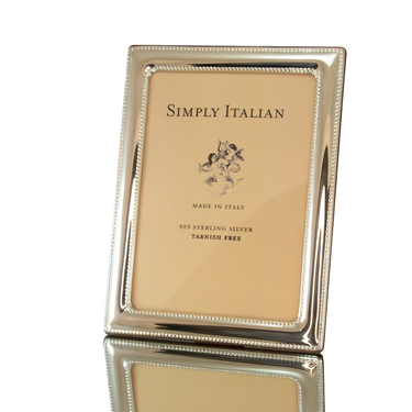 A silver picture frame with a double beaded design, labeled 'Simply Italian' and indicating a size of 10cm x 15cm, made of 925 sterling silver with a polished wood back, tarnish-free.