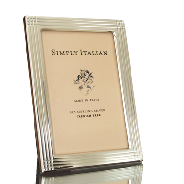 A sterling silver picture frame with a polished wood back, Made in Italy, with a 10cm x 15cm inside measurement.