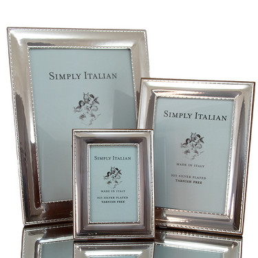 A light silver, wood veneer back, stitch etched, photo frame. Made in Italy, with a tarnish-free finish.