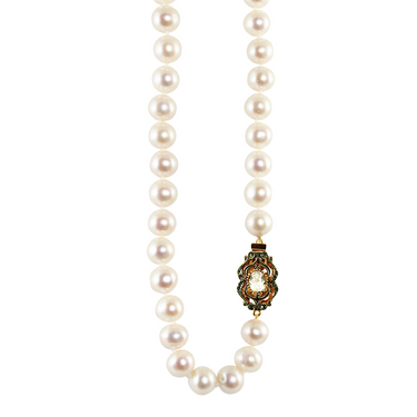 A white cultured freshwater pearl necklace with a bright crystal clasp and intricate detailing on the clasp.