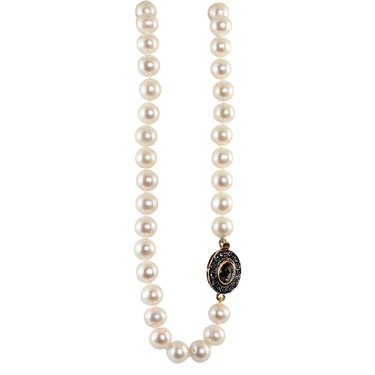 A white pearl necklace with fume crystal accents and a 18ct rose gold and sterling silver clasp.