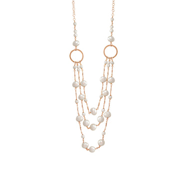 A triple strand necklace featuring white pearls and gold circle links