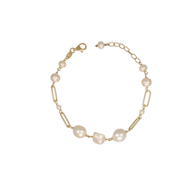 A delicate gold chain bracelet featuring irregular white pearls, paperclip links, and small clear accent beads.
