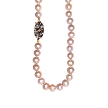 A pink freshwater pearl necklace with a floral patterned crystal clasp made of 18ct rose gold and 925 sterling silver.